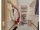 Well-organized closet with hanging clothes, shelves, and storage bins at 13226 W Mesa Verde Dr, Sun City West, AZ 85375