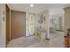 Entryway with tiled floors, stained glass window, and a console table at 13226 W Mesa Verde Dr, Sun City West, AZ 85375