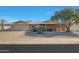 Brick ranch house with a two-car garage and nicely landscaped front yard at 13226 W Mesa Verde Dr, Sun City West, AZ 85375