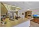 Galley kitchen with ample counter space and wood cabinets at 13226 W Mesa Verde Dr, Sun City West, AZ 85375