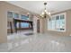 Bright dining room with marble floors and a chandelier at 13611 W Merrell St, Avondale, AZ 85392