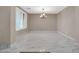 Bright dining room featuring elegant chandelier and marble-look flooring at 13611 W Merrell St, Avondale, AZ 85392