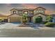 Two-story house with a three-car garage and landscaped front yard at 13611 W Merrell St, Avondale, AZ 85392