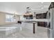 Modern kitchen with dark cabinets, granite counters, and island at 13611 W Merrell St, Avondale, AZ 85392