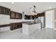 Modern kitchen with dark cabinetry, granite counters, and stainless steel appliances at 13611 W Merrell St, Avondale, AZ 85392