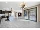 Open concept kitchen flows into dining area with marble floors at 13611 W Merrell St, Avondale, AZ 85392