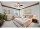 Main bedroom with sitting area, marble floors, and ceiling fan at 13611 W Merrell St, Avondale, AZ 85392