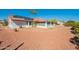 View of home's backyard with stone pathway and solar panels at 14103 W Casa Linda Dr, Sun City West, AZ 85375