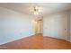 Spacious bedroom with wood flooring, ceiling fan, and mirrored closet doors at 14103 W Casa Linda Dr, Sun City West, AZ 85375