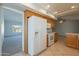 Kitchen area with white appliances and wood cabinets at 14103 W Casa Linda Dr, Sun City West, AZ 85375