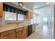 Kitchen with double sink, light wood cabinets, and tile floors at 14103 W Casa Linda Dr, Sun City West, AZ 85375