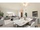 Bright living room and dining area boasts neutral colors and modern finishes at 14103 W Casa Linda Dr, Sun City West, AZ 85375