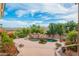 Expansive backyard featuring a refreshing pool with rock accents, mature trees, and picturesque mountain views at 15701 E Greystone Dr, Fountain Hills, AZ 85268