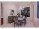 Elegant dining room with modern chandelier, stylish table setting, and large window showcasing the outdoor view at 15701 E Greystone Dr, Fountain Hills, AZ 85268