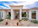 Inviting home entrance featuring tile walkway and a unique front door framed by desert landscaping at 15701 E Greystone Dr, Fountain Hills, AZ 85268