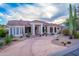 Expansive desert home boasting a circular drive and elegant columns framing the entrance and lush, native landscaping at 15701 E Greystone Dr, Fountain Hills, AZ 85268