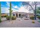 Charming desert home showcasing native landscaping, a tile roof and a welcoming entrance with well-manicured yard at 15701 E Greystone Dr, Fountain Hills, AZ 85268