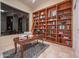 Spacious home office featuring a built-in bookshelf with library ladder and a large window for natural light at 15701 E Greystone Dr, Fountain Hills, AZ 85268