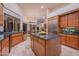 Open concept kitchen featuring an island, stainless steel appliances, granite countertops, and wood cabinets at 15701 E Greystone Dr, Fountain Hills, AZ 85268