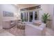 Bright living room featuring stylish seating, an patterned ottoman, and access to the outdoors through sliding glass doors at 15701 E Greystone Dr, Fountain Hills, AZ 85268