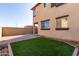 Artificial turf backyard with a paved patio area at 15913 S 11Th Way, Phoenix, AZ 85048