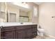 Bathroom with dark wood vanity, large mirror and shower at 15913 S 11Th Way, Phoenix, AZ 85048