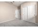 Bedroom with carpet, double doors to closet, and access to hallway at 15913 S 11Th Way, Phoenix, AZ 85048