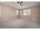 Spacious bedroom with ceiling fan and plush carpeting at 15913 S 11Th Way, Phoenix, AZ 85048