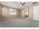 Large bedroom with ceiling fan, carpet, and ensuite bathroom access at 15913 S 11Th Way, Phoenix, AZ 85048