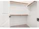 Walk-in closet with wood shelving and hanging rods at 15913 S 11Th Way, Phoenix, AZ 85048