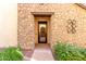 Front entry with stone facade and black door at 15913 S 11Th Way, Phoenix, AZ 85048