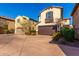 Three-story tan house with a brown garage door and walkway at 15913 S 11Th Way, Phoenix, AZ 85048