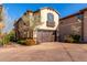 Three story home with a brown garage door and landscaping at 15913 S 11Th Way, Phoenix, AZ 85048