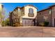 Tan three story home with a brown garage door and landscaping at 15913 S 11Th Way, Phoenix, AZ 85048