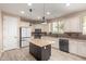 Modern kitchen with granite island, stainless steel appliances, and ample cabinet space at 15913 S 11Th Way, Phoenix, AZ 85048