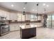 Modern kitchen with granite countertops, stainless steel appliances, and breakfast bar at 15913 S 11Th Way, Phoenix, AZ 85048