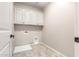 Laundry room with white cabinets and drain at 15913 S 11Th Way, Phoenix, AZ 85048