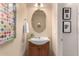 Modern bathroom with an updated vanity and oval mirror at 1625 W Cool Water Way, San Tan Valley, AZ 85144