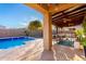 Inviting backyard oasis with a sparkling pool and covered patio at 1625 W Cool Water Way, San Tan Valley, AZ 85144