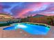 Stunning pool at night with colorful sunset at 1625 W Cool Water Way, San Tan Valley, AZ 85144