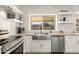 Modern kitchen with farmhouse sink, white cabinets and stainless steel appliances at 16414 N 48Th Way, Scottsdale, AZ 85254