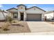 One-story home with neutral exterior, two-car garage, and small front yard at 17741 W Mission Ln, Waddell, AZ 85355