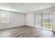 Bright living room with grey flooring and sliding glass door to backyard at 17741 W Mission Ln, Waddell, AZ 85355