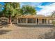 Home's backyard features a covered patio and gravel at 18449 N 46Th Ave, Glendale, AZ 85308