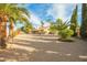 View of the house from the backyard with gravel and palm trees at 18449 N 46Th Ave, Glendale, AZ 85308