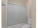 Clean bathroom with shower/tub combo and frosted glass sliding door at 18449 N 46Th Ave, Glendale, AZ 85308