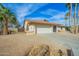 House exterior featuring a two-car garage and desert landscaping at 18449 N 46Th Ave, Glendale, AZ 85308