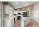 Kitchen with white cabinets, a large island, and stainless steel appliances at 18449 N 46Th Ave, Glendale, AZ 85308