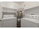 Laundry room with washer, dryer, and ample shelving at 18449 N 46Th Ave, Glendale, AZ 85308