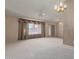 Bright living room featuring a large window and neutral carpeting at 18449 N 46Th Ave, Glendale, AZ 85308